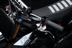 Close-up of a motorcycle handlebar with visible branding on a dark background