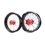 Pair of motorcycle wheels with red spokes on a white background