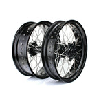 Two motorcycle wheels with black rims on a white background
