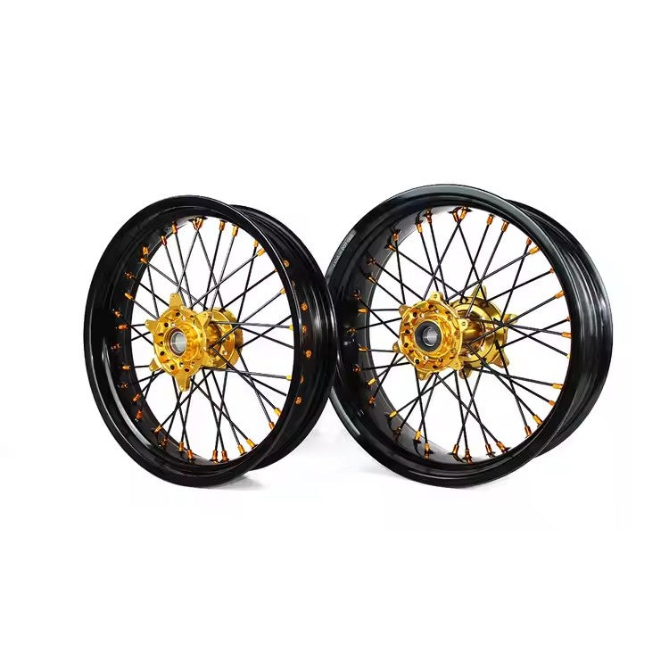 Pair of motorcycle wheels with gold center hubs on a white background