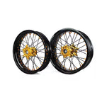 Pair of motorcycle wheels with gold center hubs on a white background