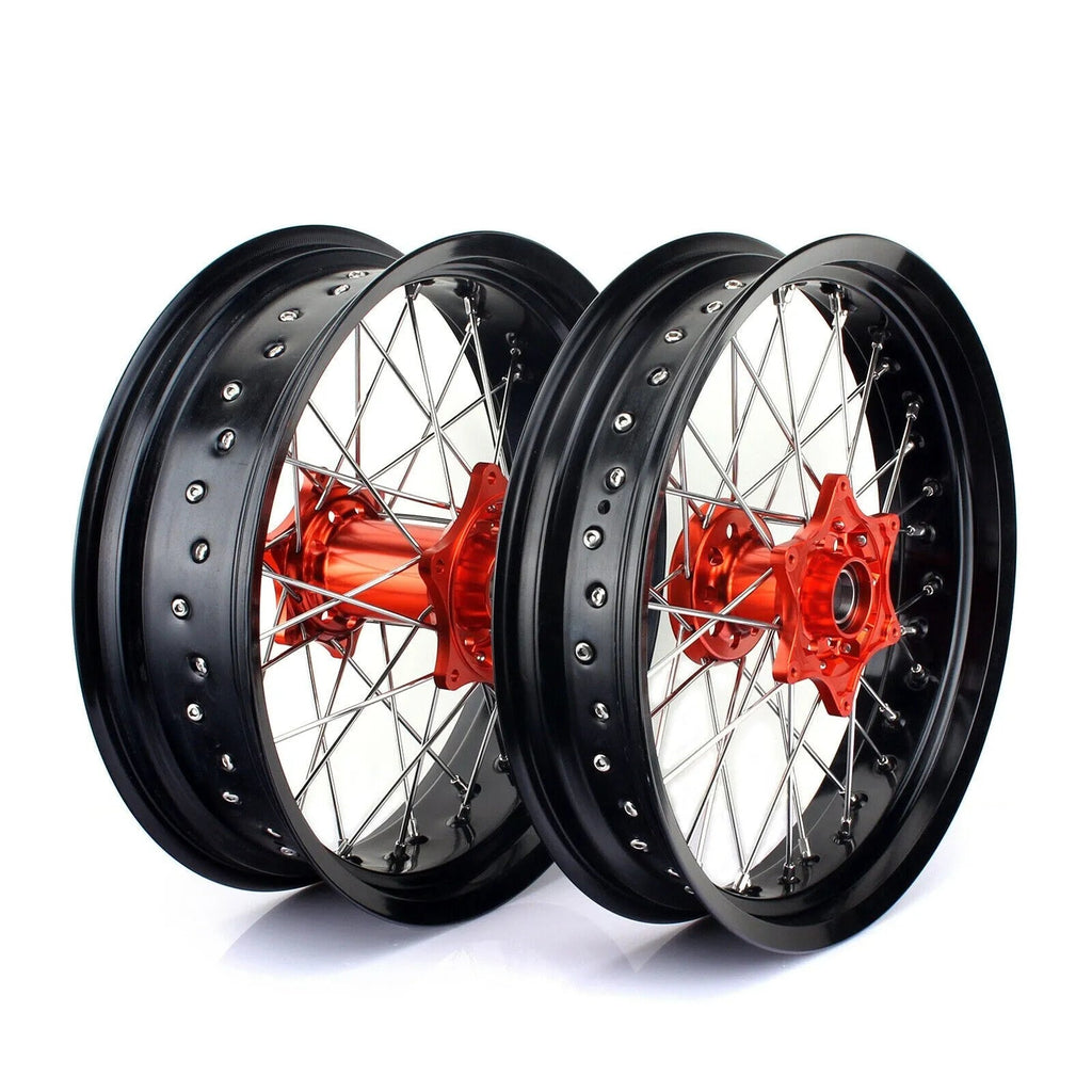 Two motorcycle wheels with black rims and red hubs on a white background