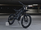 Black electric dirt bike in a dimly lit indoor setting with 'LUNA' branding.