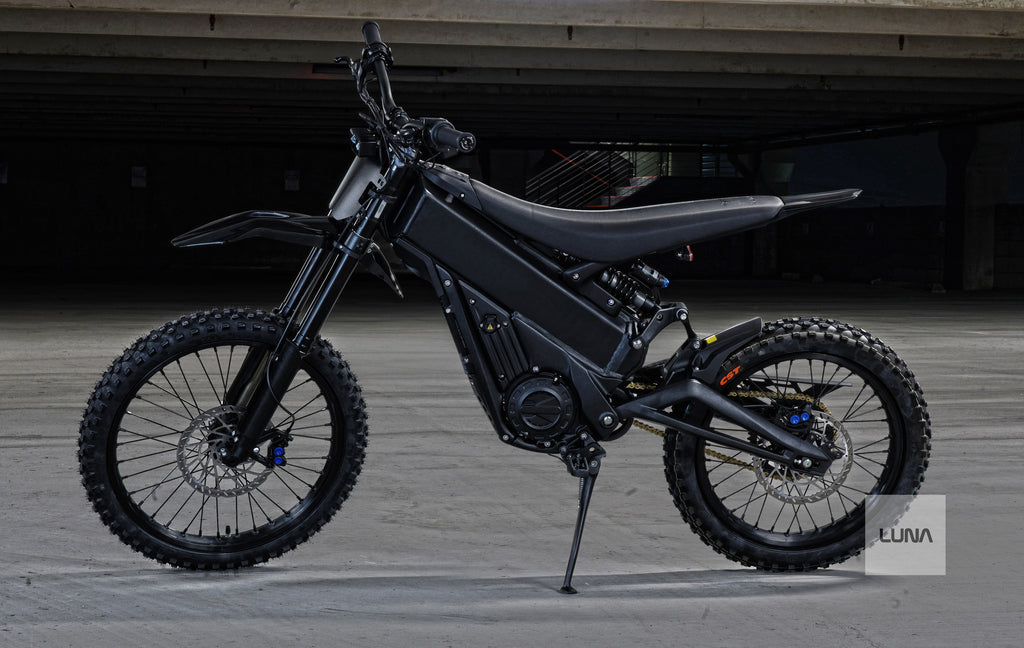 Black electric dirt bike with 'Luna' branding on a gray background