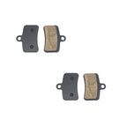 Two pairs of brake pads on a white background