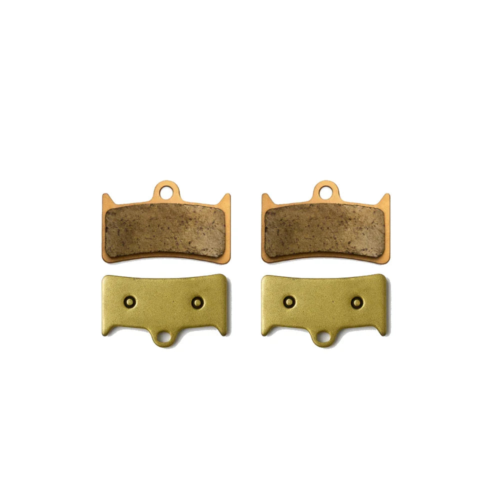 Set of four brake pads on a white background