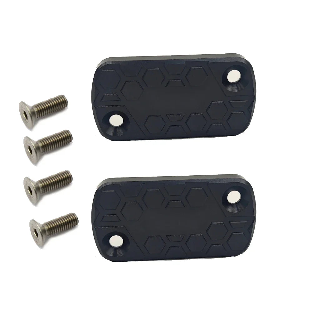 Two black rubber foot pads with hexagonal pattern and four screws on a white background