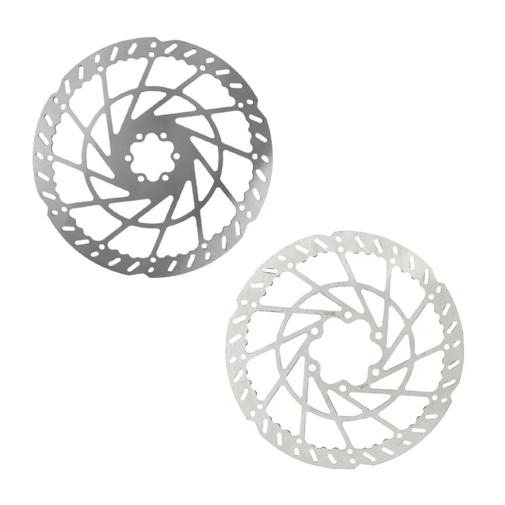 Two metallic bike disc rotors on a white background