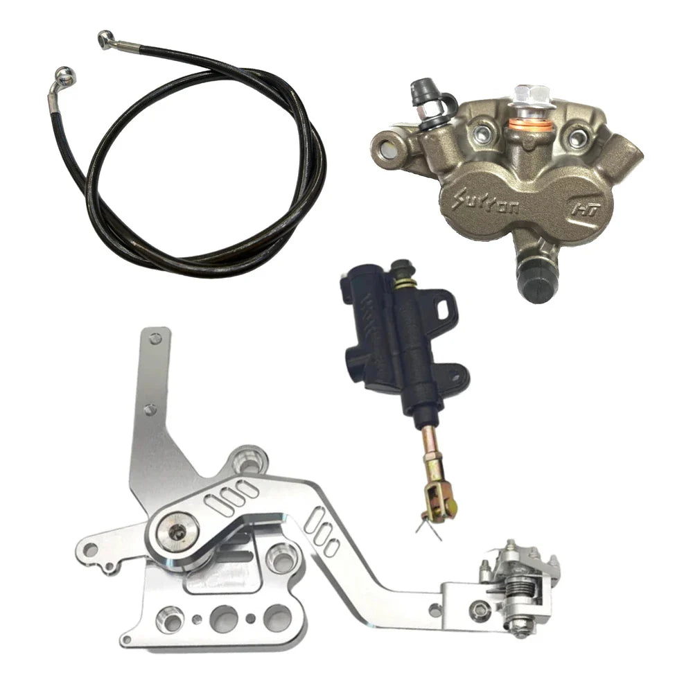 Collection of mechanical components including a brake caliper, bracket, and cable on a white background