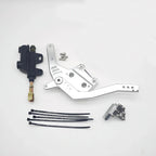 Mechanical parts including a silver lever, black cable, and metal components on a white background